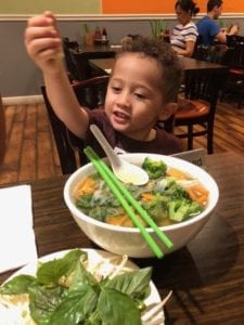 Raising a foodie: 3 year old eating a bowl of vegan pho.