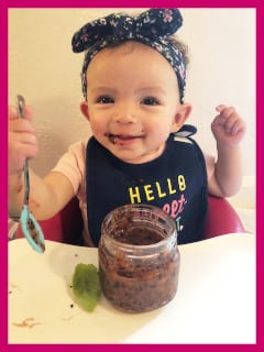 6-month-old Emmalee enjoying Persimmon, Blueberry & Basil puree.