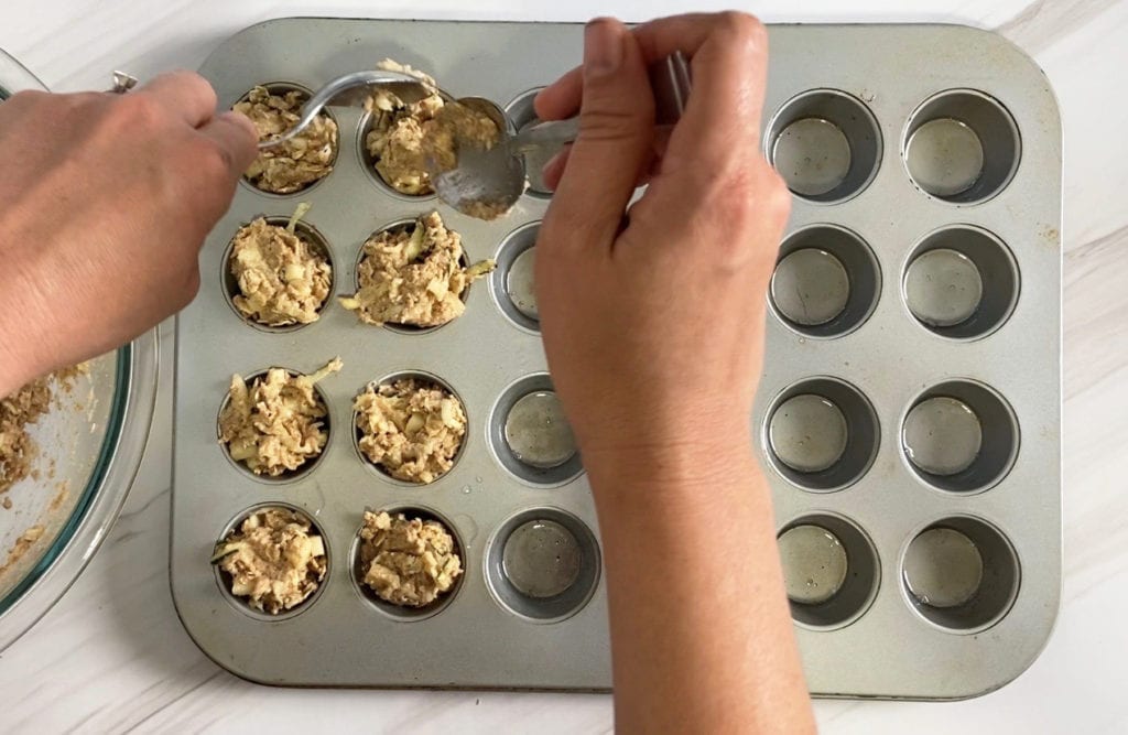 Making toddler zucchini + apple muffins.
