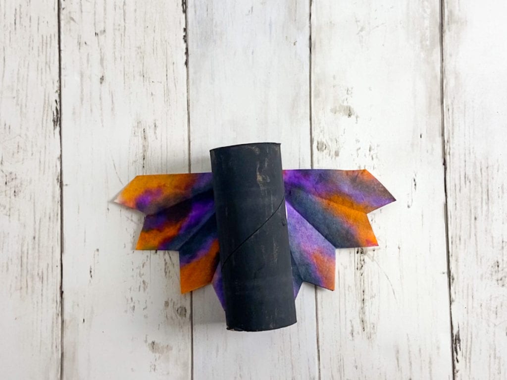 Glue the wings onto the Halloween bat craft.