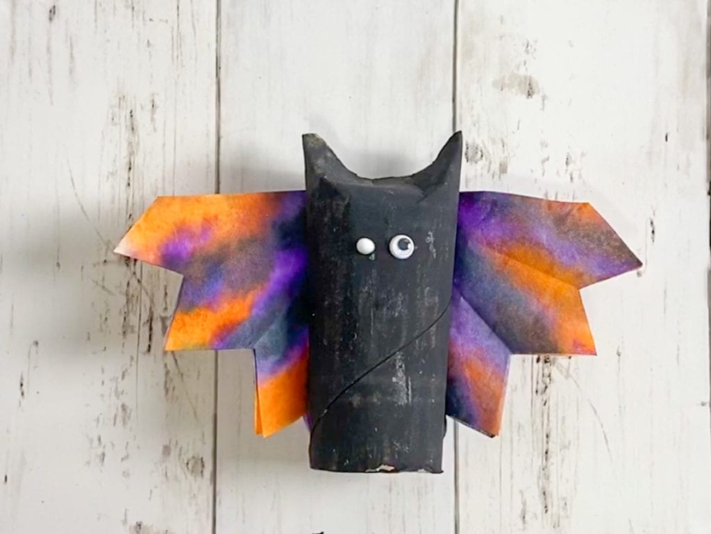 Glue the eyes onto the Halloween bat craft.