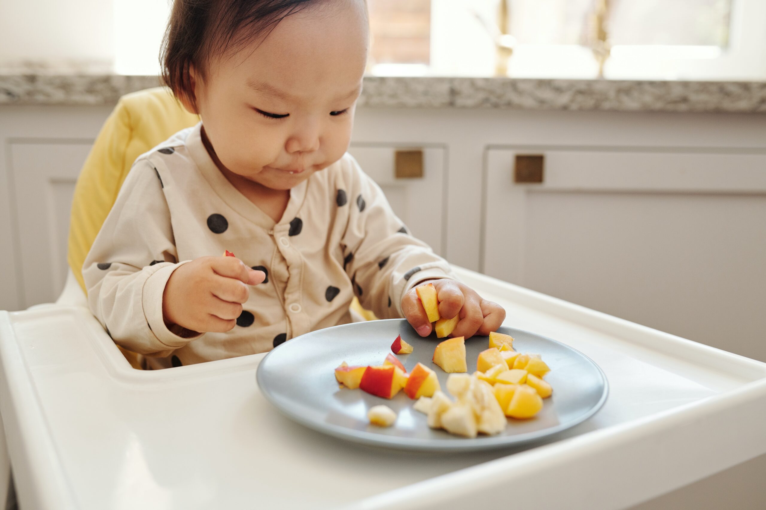 toddler eating fruit