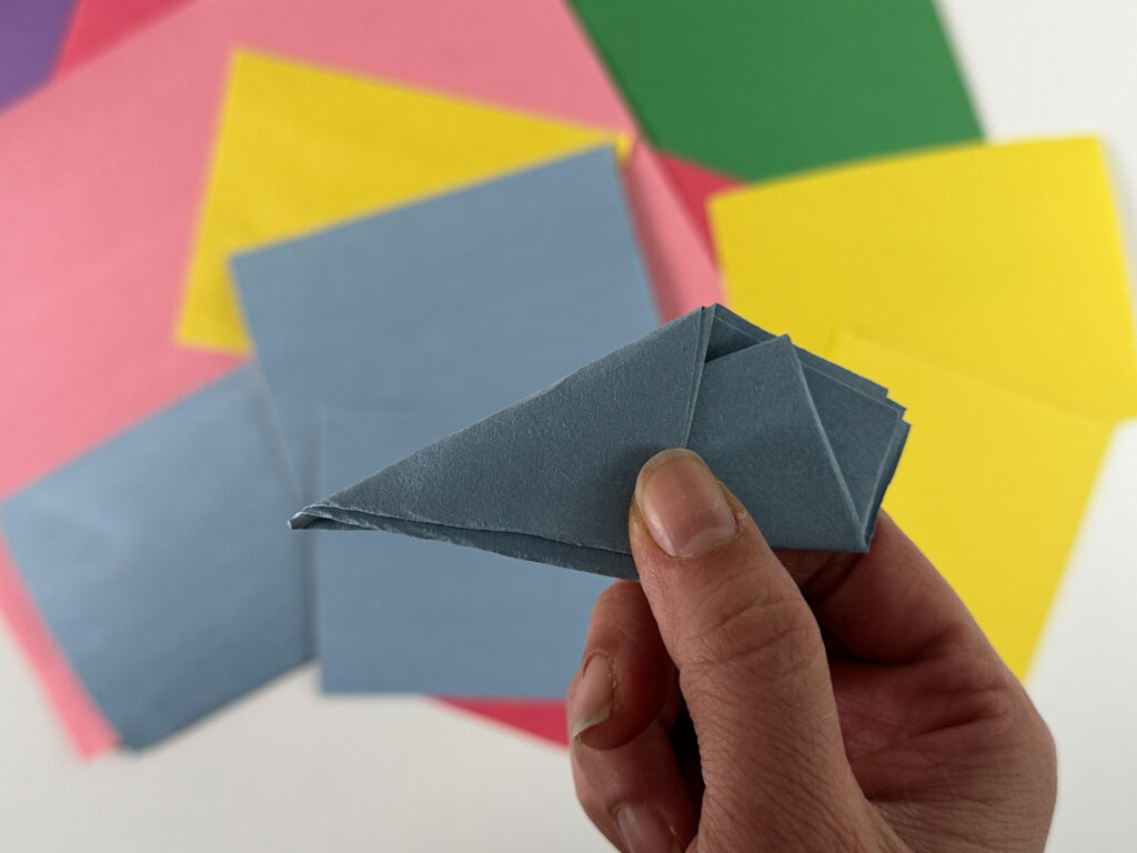 Folding paper to make snowflakes.