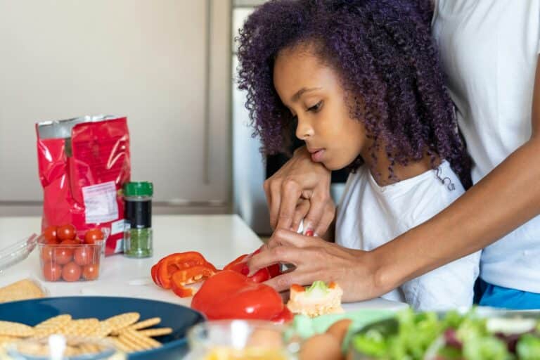 Mom and daughter cutting vegetables