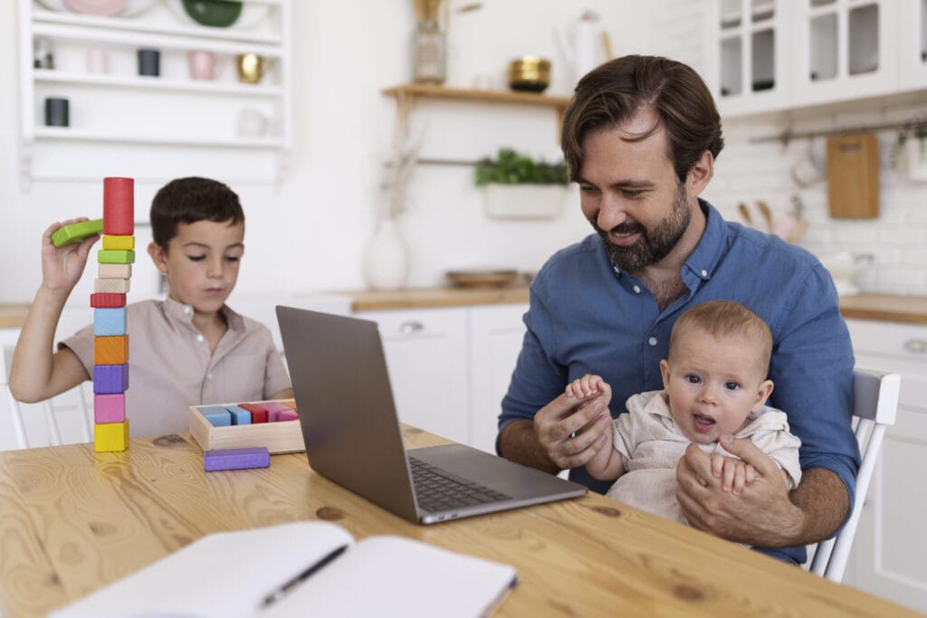 Dad working with his kids around.