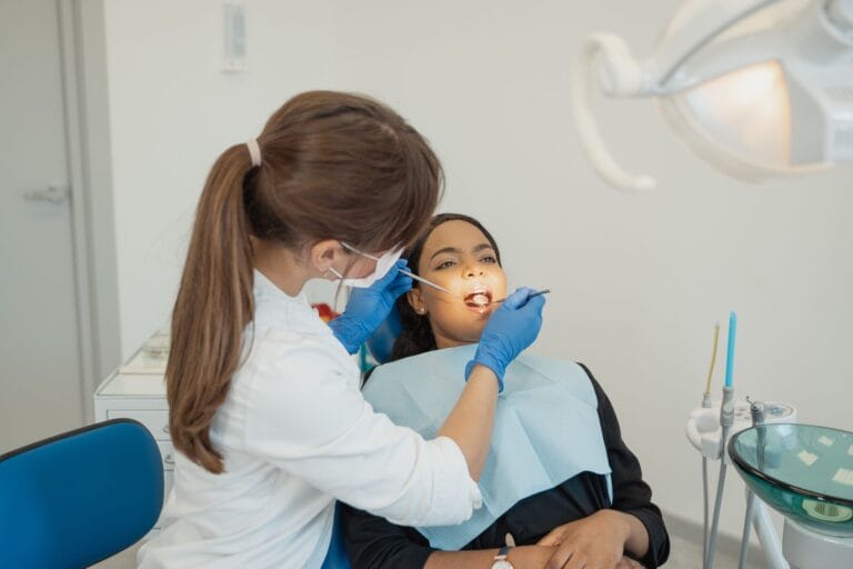 Dentist conducting a dental examination on a patient in a modern clinic setting.