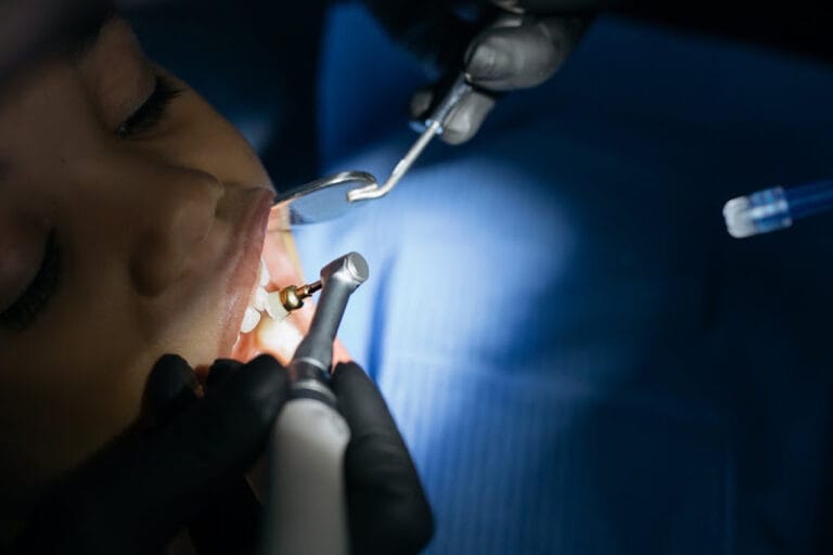 dentist cleaning boy's teeth