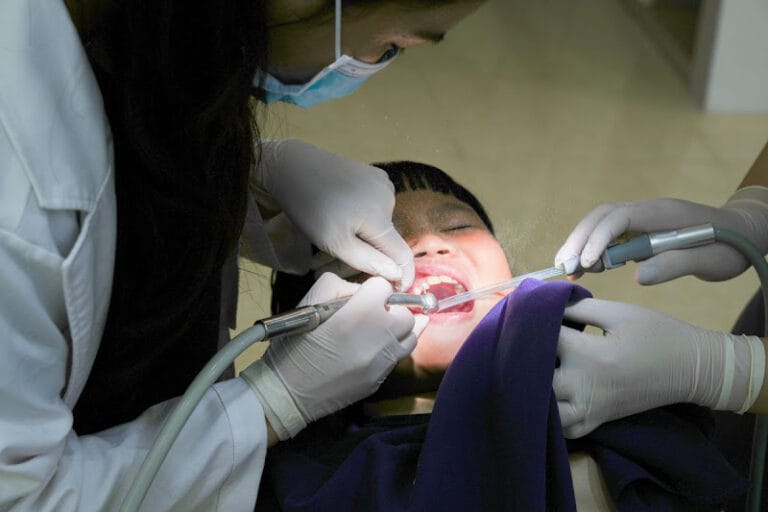 dentist cleaning child's teeth