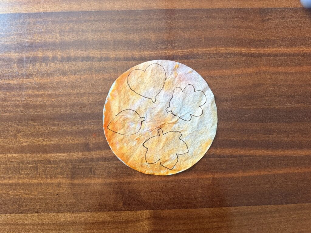 colored coffee filter with leaves traced on it