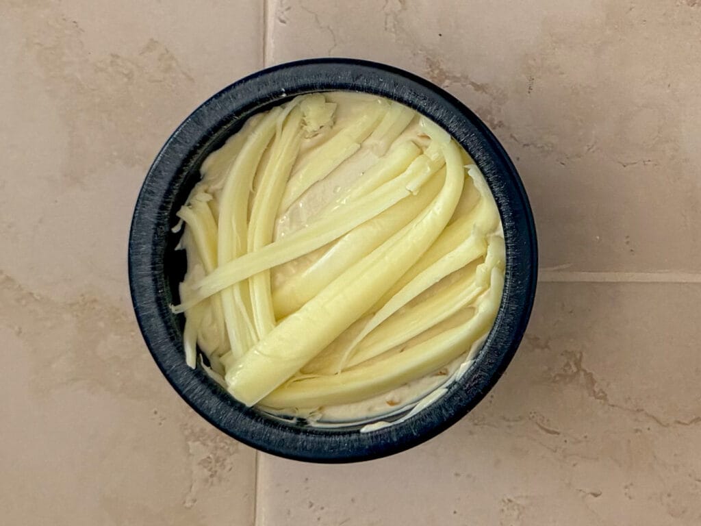Strips of string cheese arranged over creamy onion dip to resemble mummy bandages.