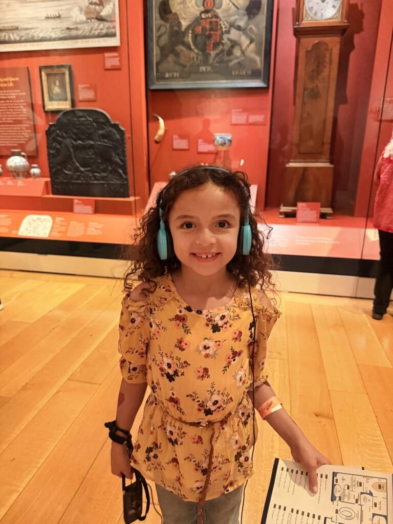 Girl with audio tour headphones in museum