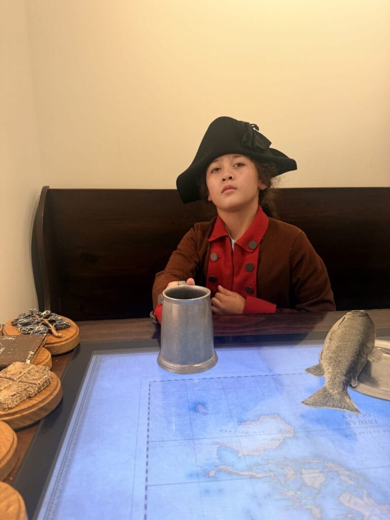 Boy dressing up in 1700s clothes at the Museum of American Revolution