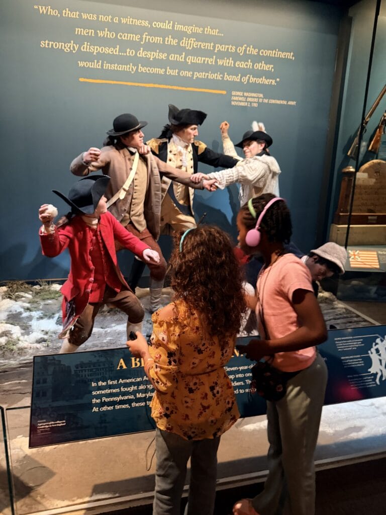 Girls looking at the exhibit at the Revolutionary War Museum