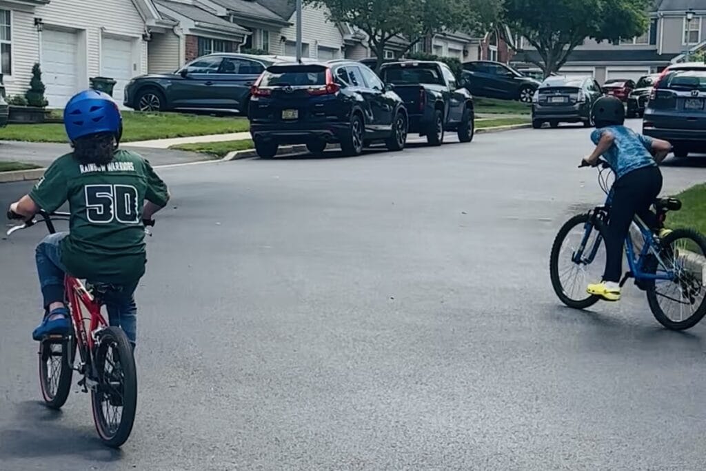 Boys riding bikes in the neighborhood.