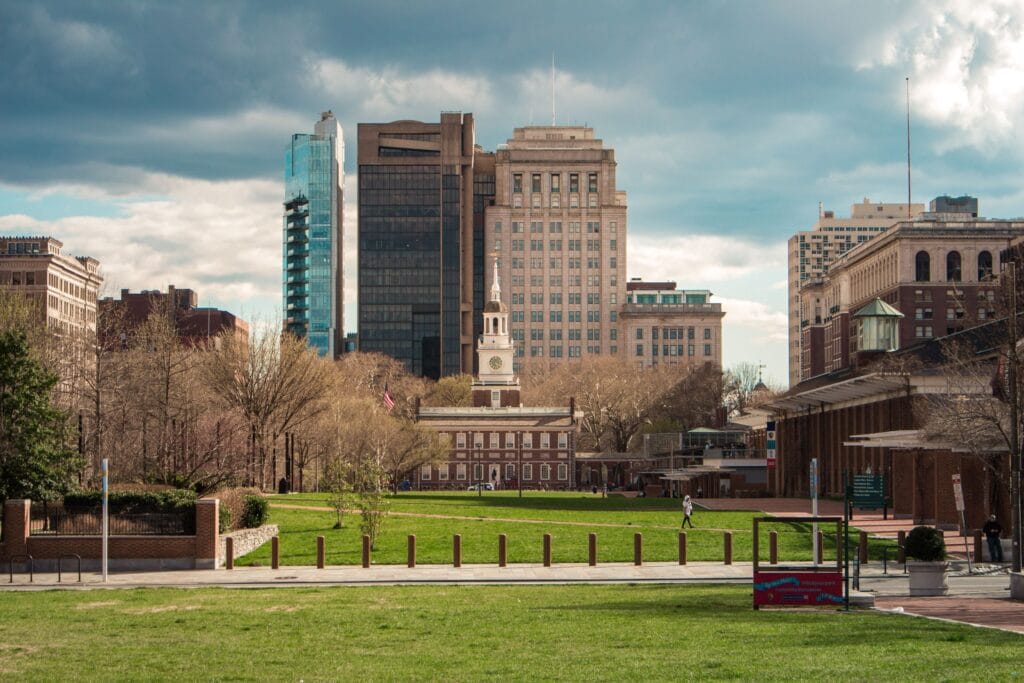Scenic view of Independence Hall with modern Philadelphia skyline in the background.